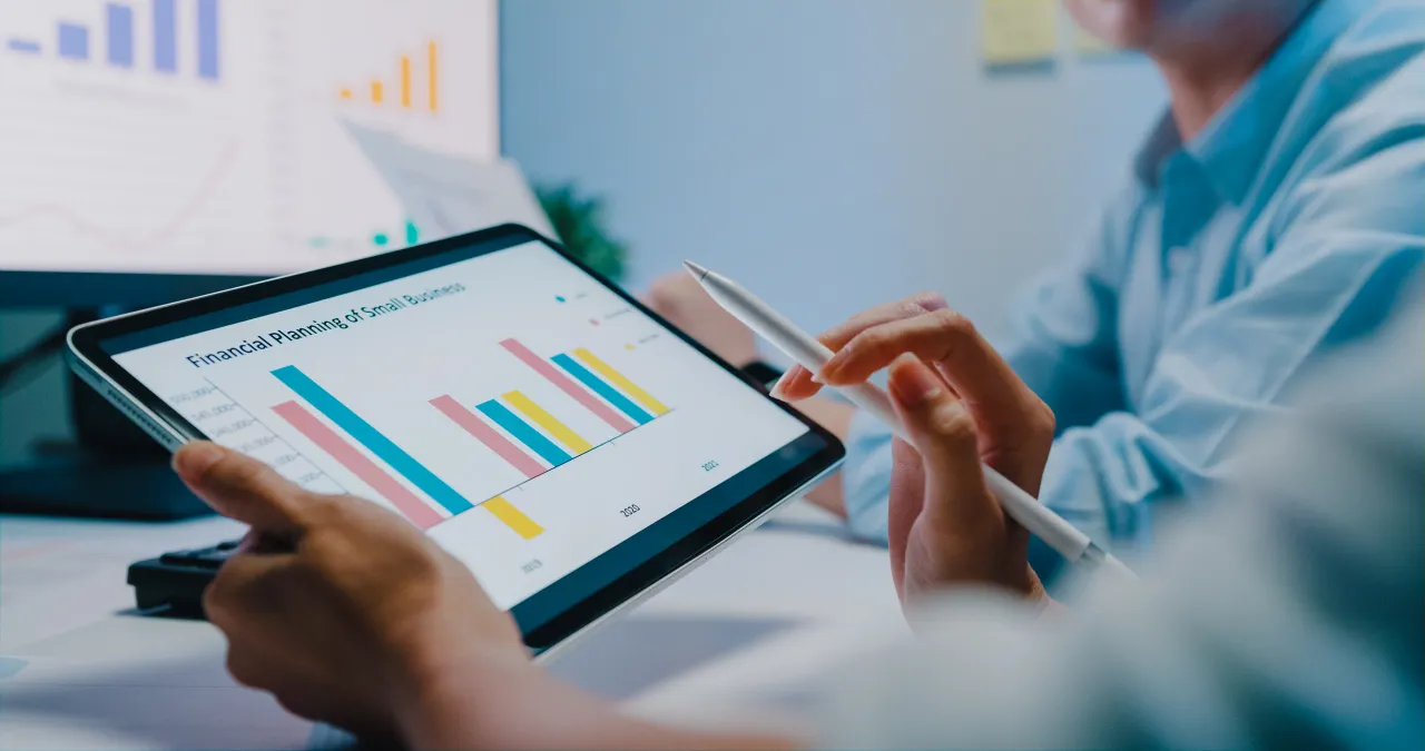 Tablet showing colorful financial bar charts