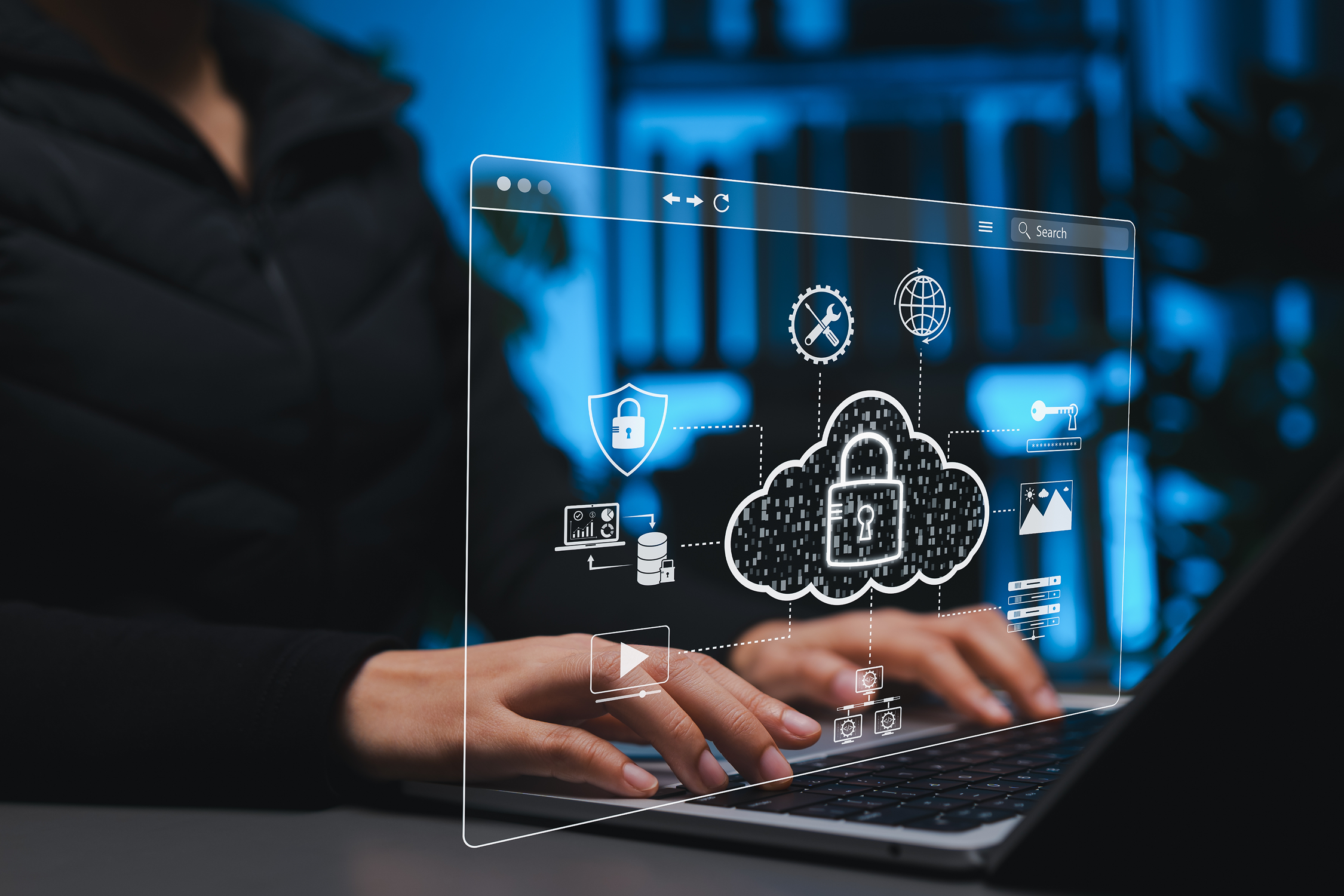Hands typing on laptop with cloud security overlay